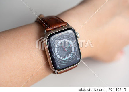 Wearable device wrapped around a woman's arm Brown leather belt watch 92150245