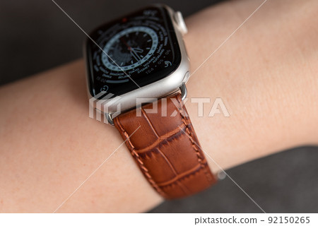 Wearable device wrapped around a woman's arm Brown leather belt watch Wearable device wrapped around a woman's arm Brown leather belt watch 92150265