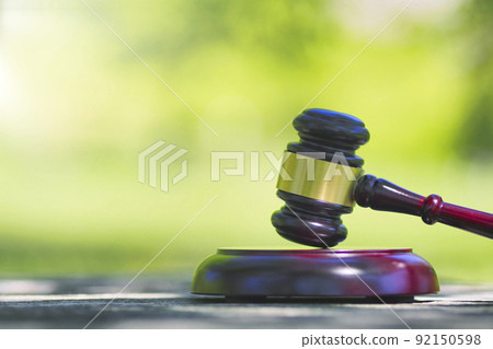 Gavel and green blur background 92150598