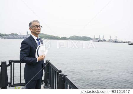 Men walking along the beach Senior middle-aged Japanese Men walking along the beach Senior middle-aged Japanese 92151947