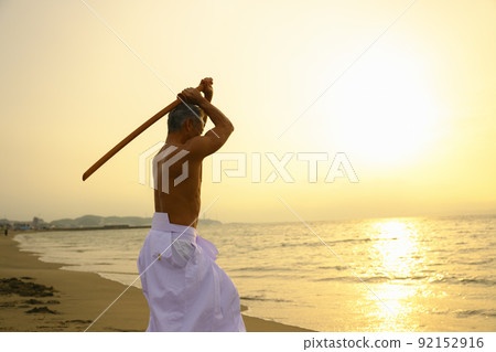 A male senior Japanese kendo master who wields a bamboo sword A male senior Japanese kendo master who wields a bamboo sword 92152916