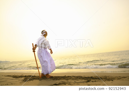 A male senior Japanese kendo master who wields a bamboo sword A male senior Japanese kendo master who wields a bamboo sword 92152943
