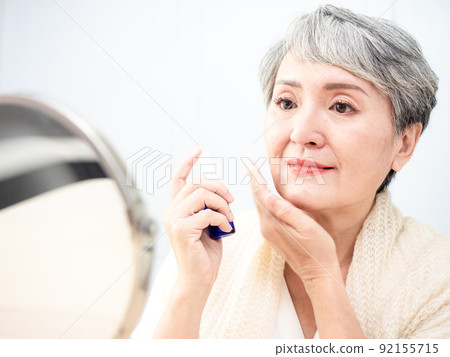 60 A perfume-like portrait of a mature woman in a bedroom. 60 A perfume-like portrait of a mature woman in a bedroom. 92155715