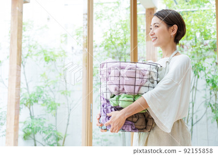 A young lady with a laundry basket A young lady with a laundry basket 92155858