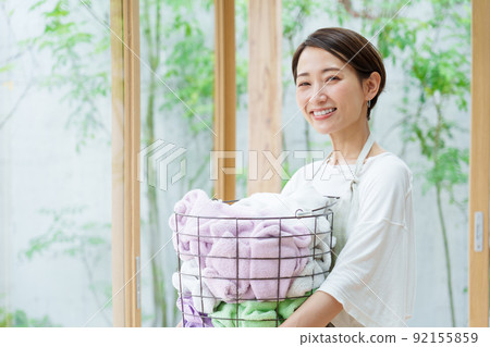 A young lady with a laundry basket A young lady with a laundry basket 92155859