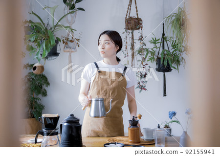 A woman doing hospitality at a house cafe A woman doing hospitality at a house cafe 92155941