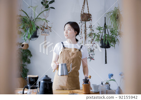 A woman doing hospitality at a house cafe A woman doing hospitality at a house cafe 92155942