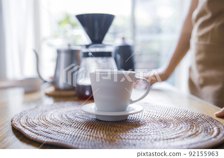 A woman doing hospitality at a house cafe A woman doing hospitality at a house cafe 92155963