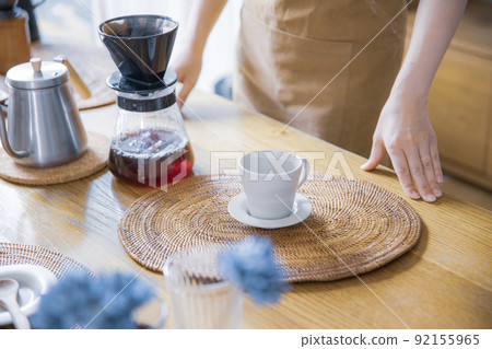 A woman doing hospitality at a house cafe A woman doing hospitality at a house cafe 92155965