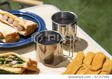 Brew and drink coffee at an outdoor camp 92157446