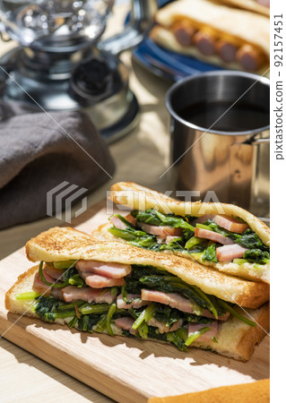 A classic camping meal that makes and eats hot sandwiches at an outdoor camp A classic camping meal that makes and eats hot sandwiches at an outdoor camp 92157451