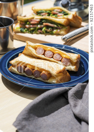 A classic camping meal that makes and eats hot sandwiches at an outdoor camp A classic camping meal that makes and eats hot sandwiches at an outdoor camp 92157463