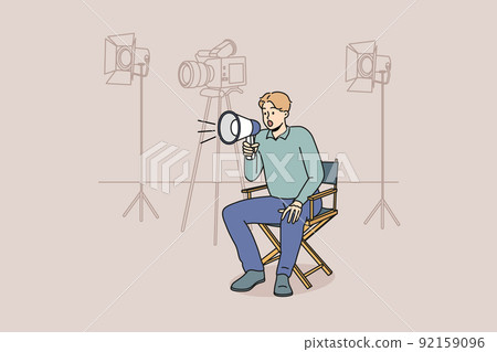 Film producer with loudspeaker at shooting scene 92159096