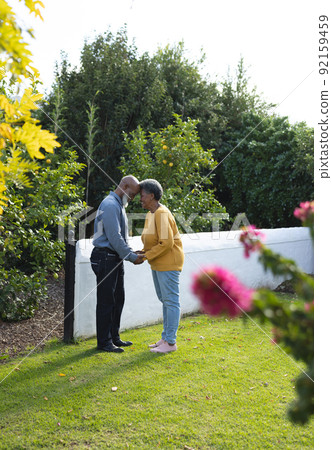 Vertical image of happy african american senior couple in garden Vertical image of happy african american senior couple in garden 92159459