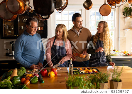 Image of happy multi generation caucasian family preparing dinner together 92159767