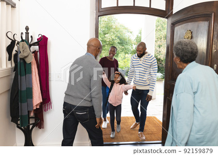 Image of happy multi generation african american family entering house and welcoming each other Image of happy multi generation african american family entering house and welcoming each other 92159879