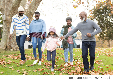 Image of happy multi generation african american family having fun outdoors in autumn 92159901