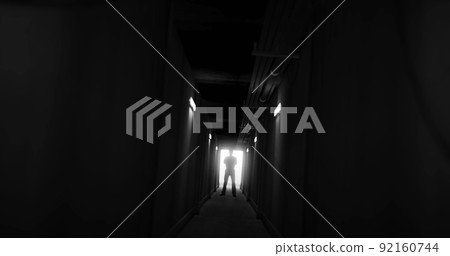Image of man silhouette standing in dark corridor Image of man silhouette standing in dark corridor 92160744