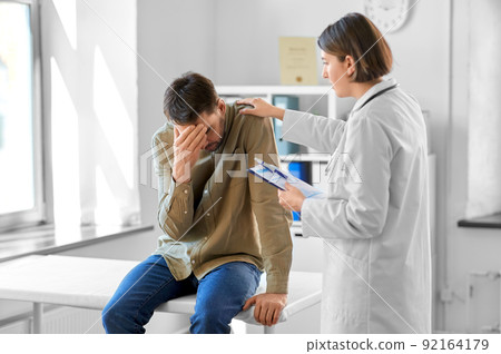 doctor and sad man with health problem at hospital doctor and sad man with health problem at hospital 92164179