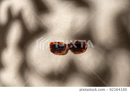 tortoiseshell sunglasses on beach sand tortoiseshell sunglasses on beach sand 92164180