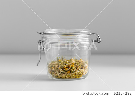 close up of jar with dried chamomile on table close up of jar with dried chamomile on table 92164282