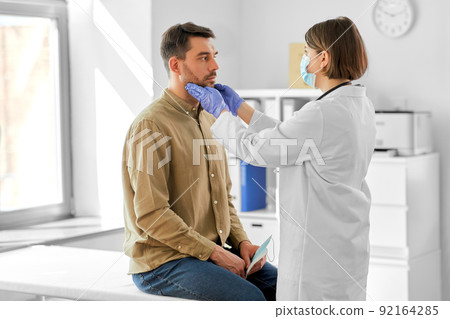 doctor checking lymph nodes of man at hospital doctor checking lymph nodes of man at hospital 92164285