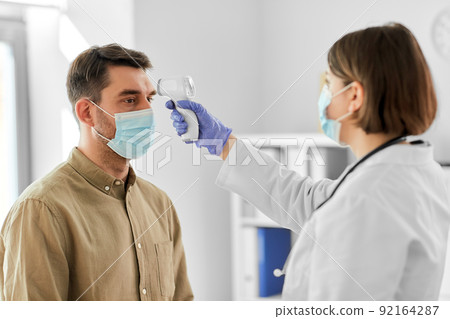 doctor with thermometer and man at hospital doctor with thermometer and man at hospital 92164287