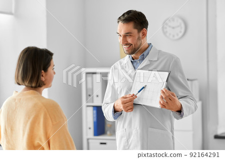 doctor showing cardiogram to woman at hospital doctor showing cardiogram to woman at hospital 92164291