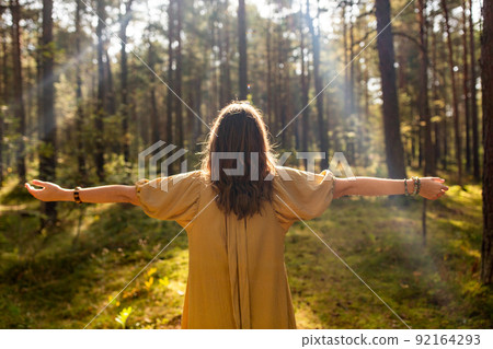 woman or witch performing magic ritual in forest 92164293