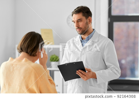 doctor and woman with health problem at hospital 92164308