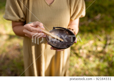 woman with palo santo performing magic ritual 92164331