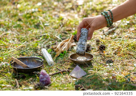 woman or witch performing magic ritual in forest woman or witch performing magic ritual in forest 92164335