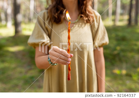 woman with candle performing magic ritual woman with candle performing magic ritual 92164337
