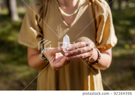 close up of woman holding magical crystal 92164398