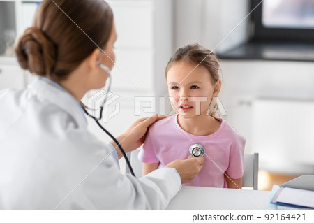doctor with stethoscope and girl patient at clinic 92164421