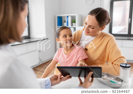 mother, child and doctor with tablet pc at clinic 92164487