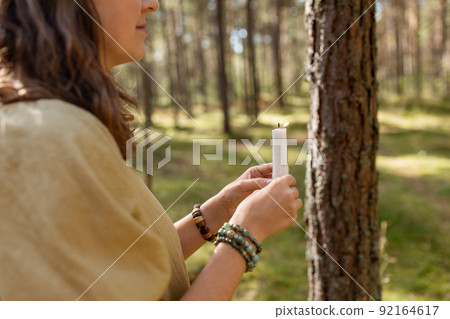 woman with candle performing magic ritual 92164617