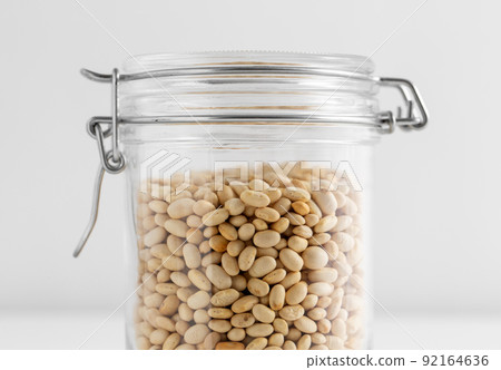 close up of jar with dried peas on white table close up of jar with dried peas on white table 92164636