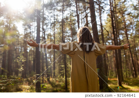 woman or witch performing magic ritual in forest 92164641