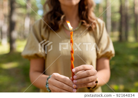 woman with candle performing magic ritual 92164834