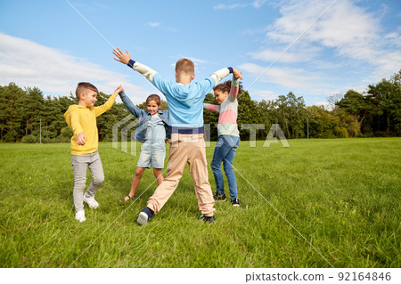 happy children playing round dance at park 92164846