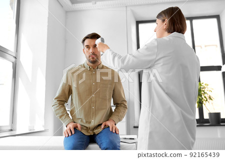 doctor with thermometer and man at hospital doctor with thermometer and man at hospital 92165439