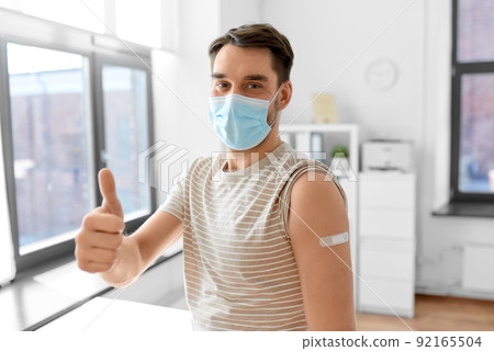 male patient in mask with patch after vaccination male patient in mask with patch after vaccination 92165504