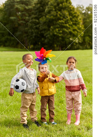 happy kids with pinwheel having fun at park 92165586