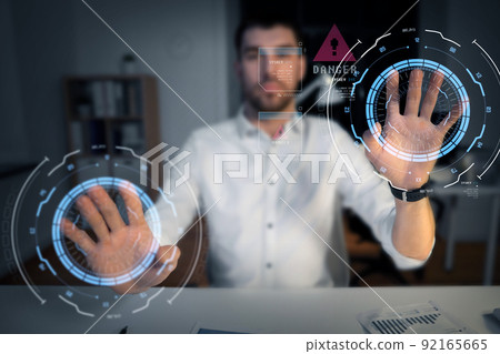 businessman using virtual screen at night office 92165665