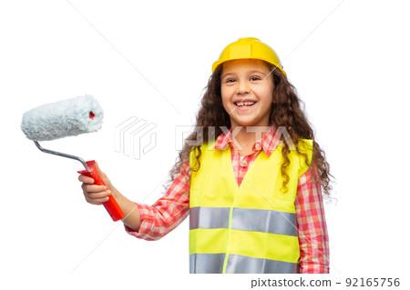 girl in helmet and safety vest with paint roller 92165756