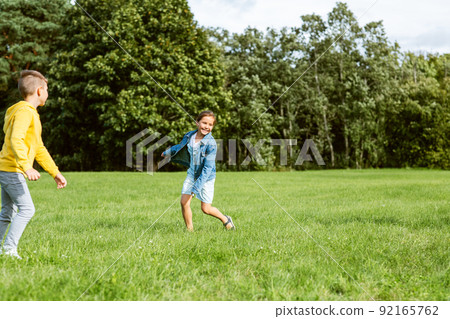happy children playing and running at park 92165762