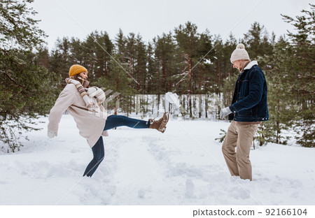 happy couple playing with snow in winter park happy couple playing with snow in winter park 92166104