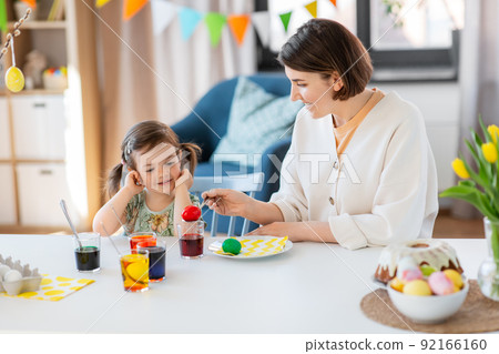 mother with child dyeing easter eggs at home mother with child dyeing easter eggs at home 92166160