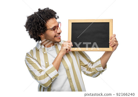 smiling man with chalkboard over white background 92166240
